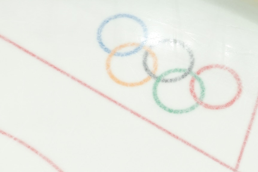 An overhead shot of the Olympic rings on ice