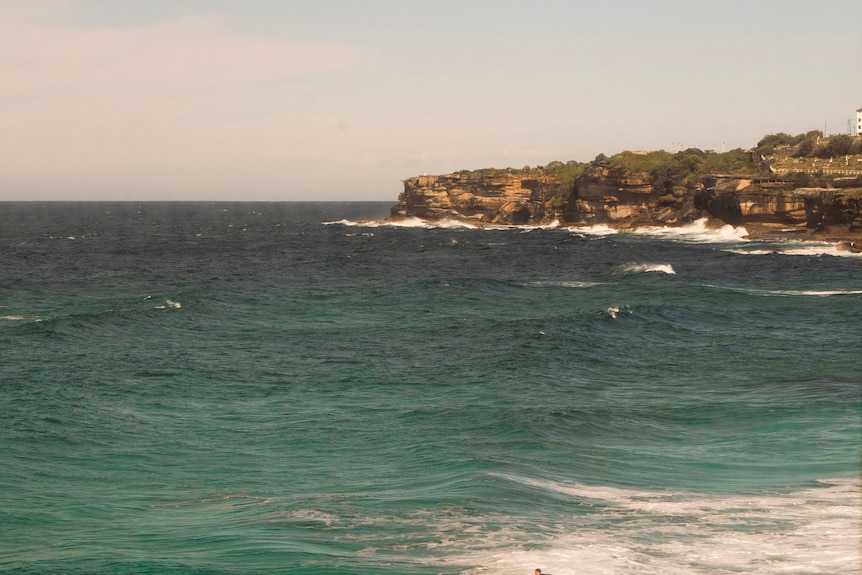 Cliff faces and water through a window.