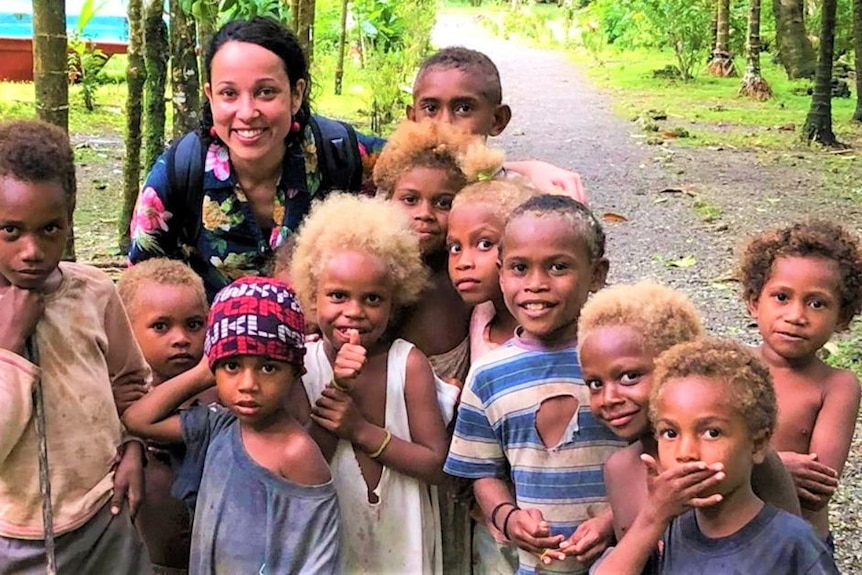 a woman surrounded by children