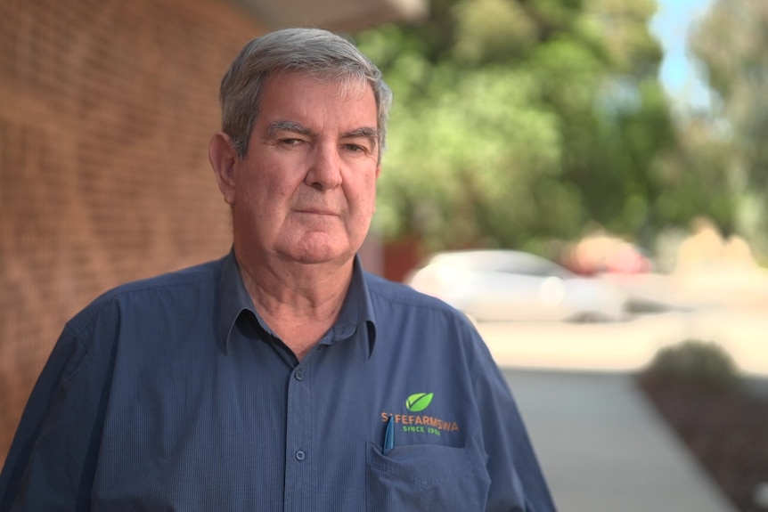 An older man in a shirt with a "Safe Farms WA" logo.