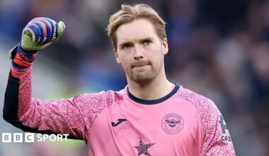 Brentford goalkeeper Caoimhin Kelleher salutes fans during a Premier League match