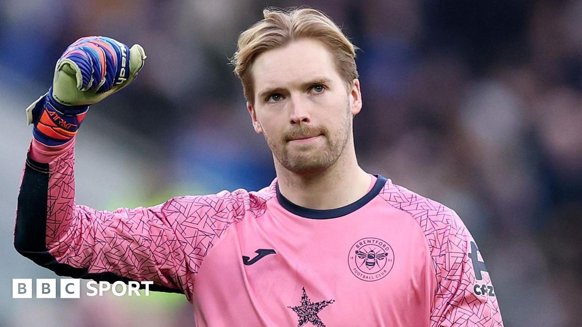 Brentford goalkeeper Caoimhin Kelleher salutes fans during a Premier League match