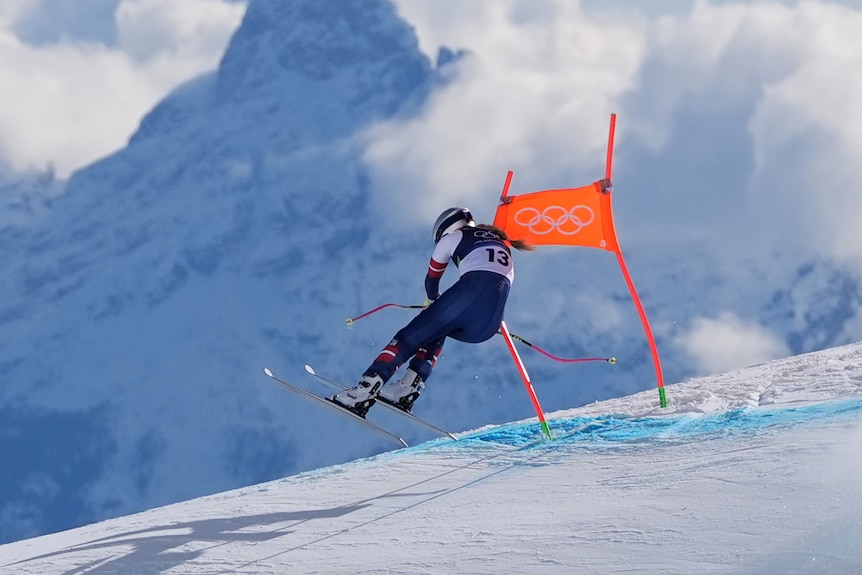 Lindsey Vonn clips a gate during her downhill run at the Winter Olympics.