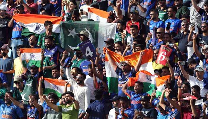 Pakistan and India’s fans are pictured with flags inside the stadium before the match in Dubai International Stadium UAE. — Reuters/File