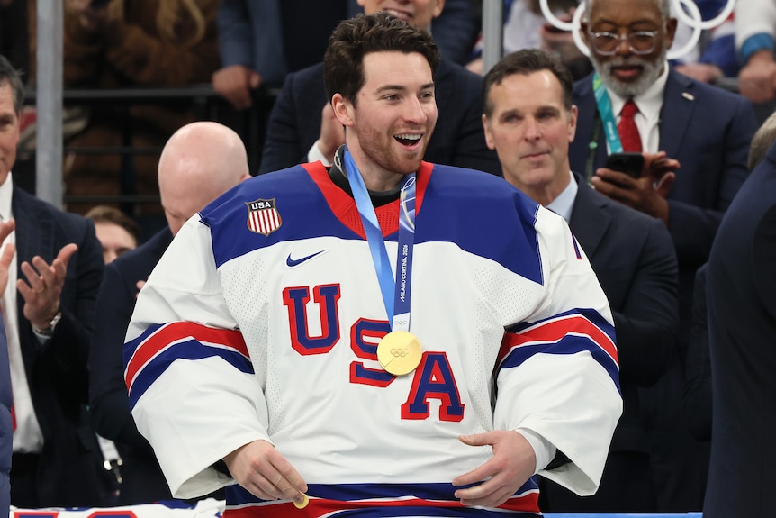 Team USA ice hockey goalkeeper Jeremy Swayman wears a gold medal at the 2026 Winter Olympics.