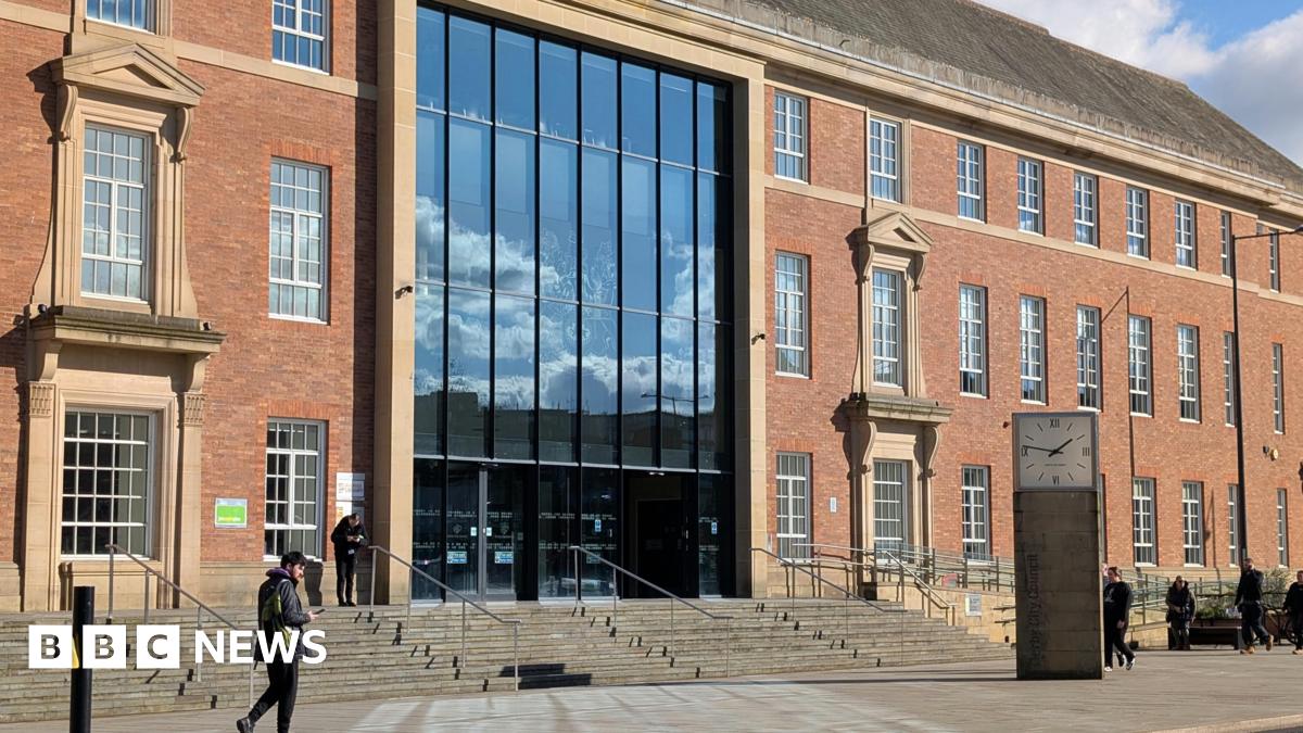 Large orange brick building with rectangular windows