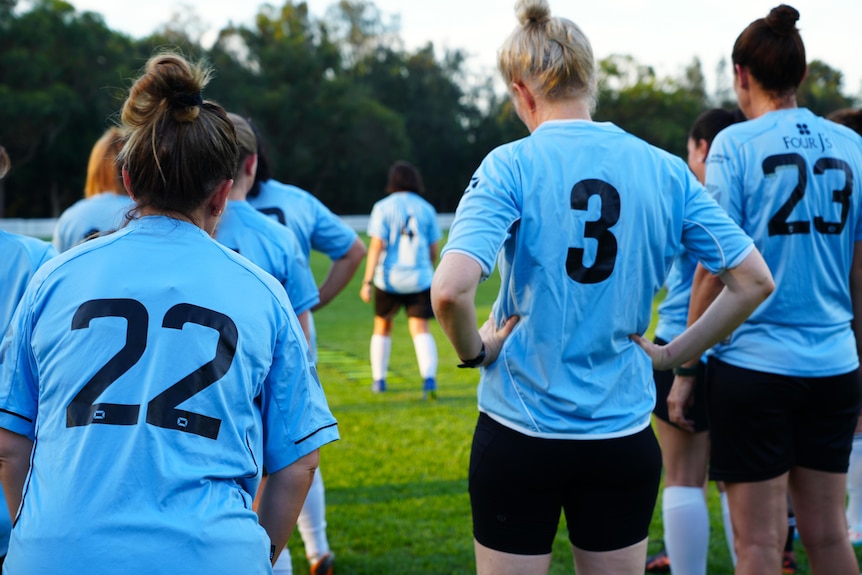 A shot from the back of female footballers training