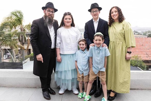 Rabbi Yaakov Levitan (left) with his family.
