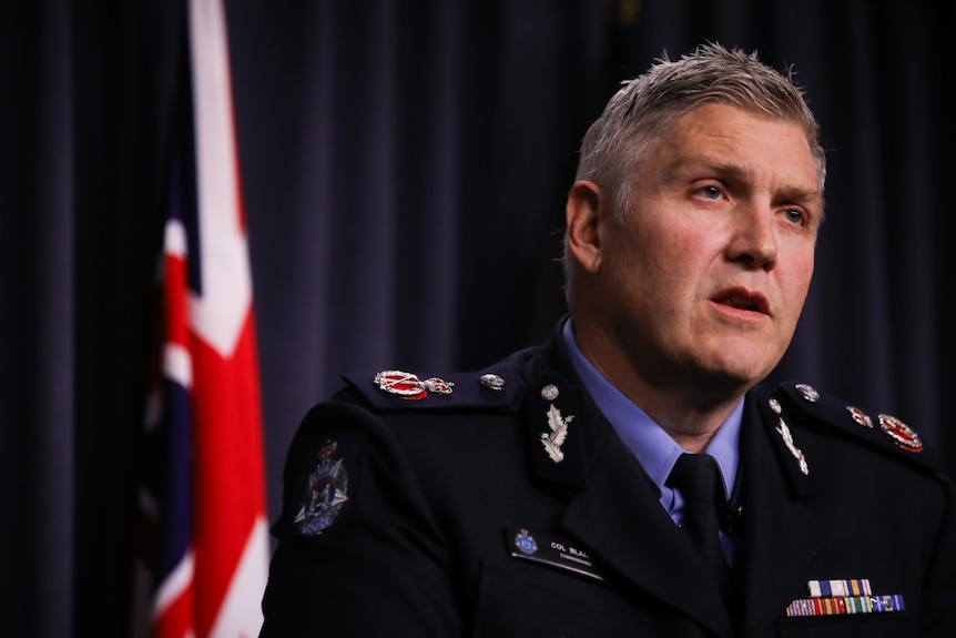A policeman speaks at a press conference