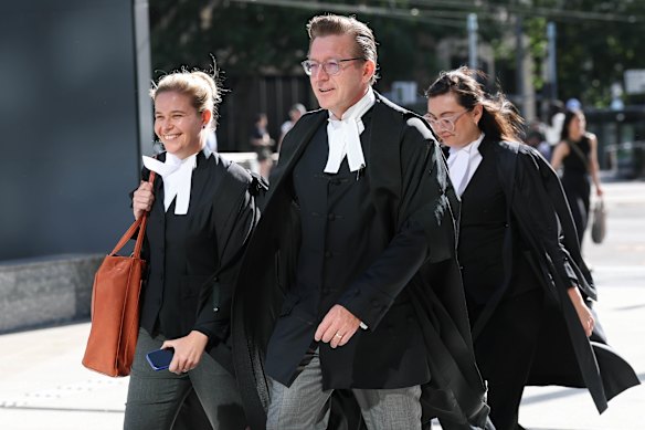 Garry Rich, SC (centre), a barrister for the ACCC, enters the Federal Court in Melbourne on Monday with colleagues Emma Bathurst (left) and Sarida McLeod.