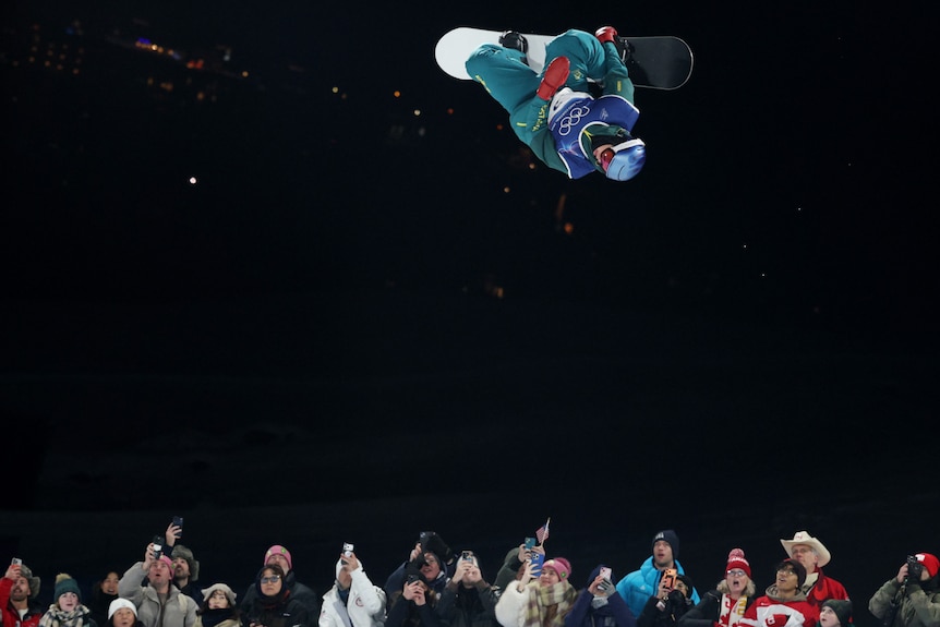 Scotty James jumps with crowd looking up
