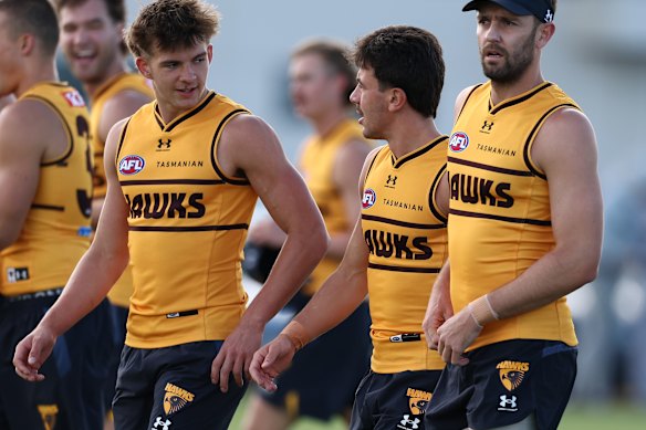 Cooper Hodge (pictured here with Massimo D’Ambrosio and Jack Gunston) trained at Hawthorn in January but is part of the Lions academy.
