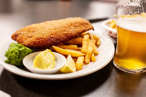 Crumbed barramundi with mushy wasabi peas and curry mayo.