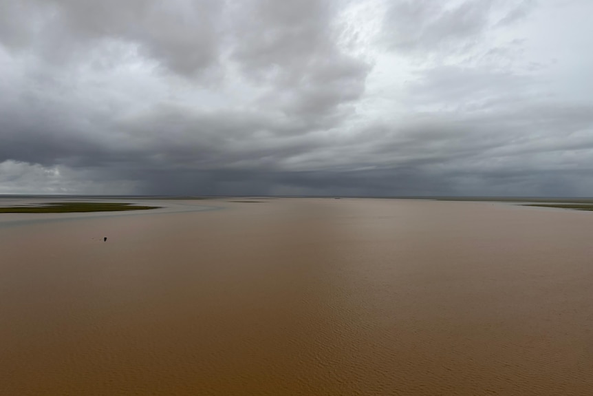 Vast amounts of floodwater stretch to the horizon.