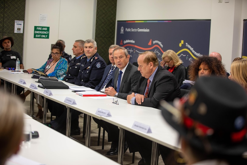 Roger Cook and government ministers sit at a table in a room with WA Aboriginal leaders.