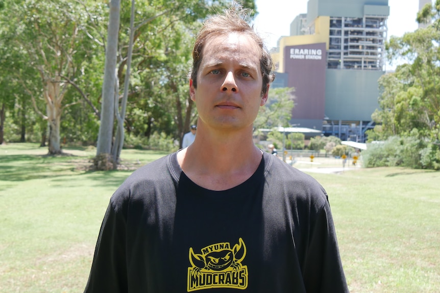 A man stands in front of the Eraring Coal Fired Power station 