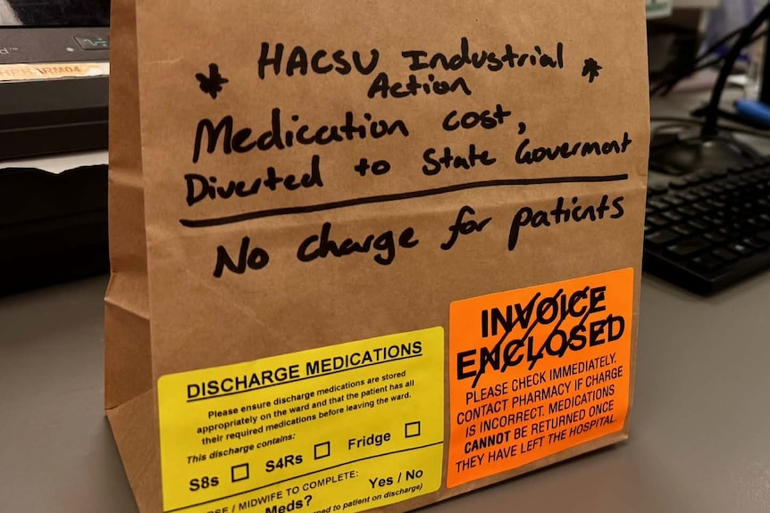 A brown paper bag with hand-written instructions to divert the cost of pharmaceutical medication to the Tasmanian Government.