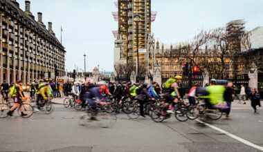 people riding bicycles on road during daytime