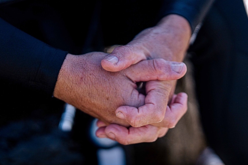 Man sits and reflects at the beach