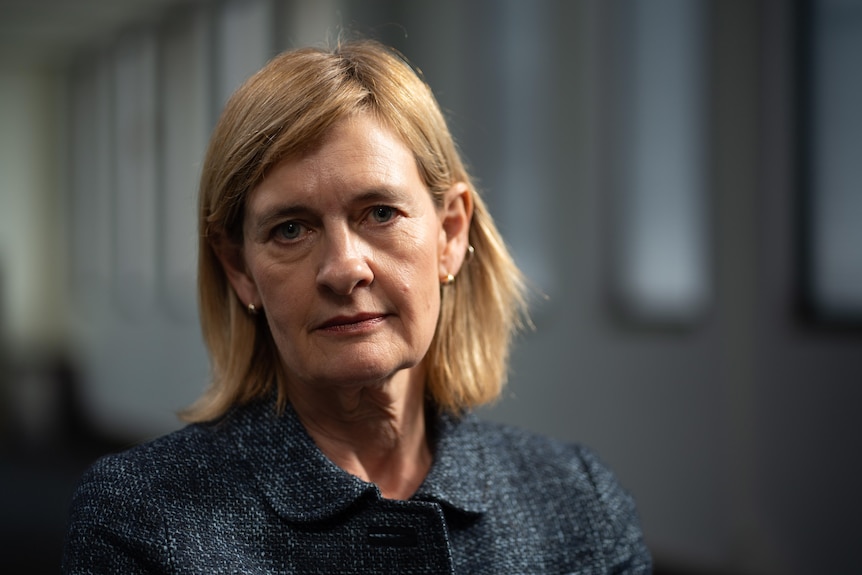 A woman, looking serious.