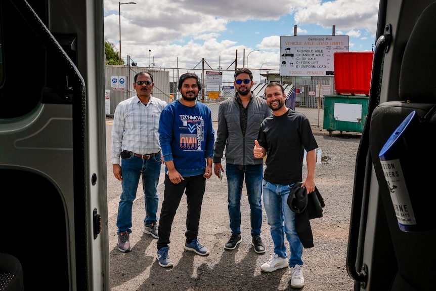 Four men smile after docking at Gellibrand port in Williamstown