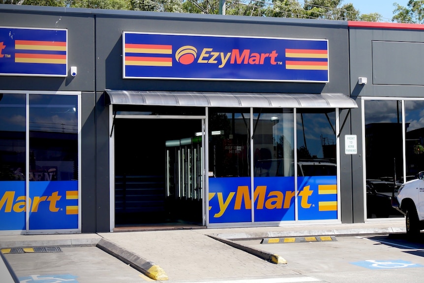 An EzyMart convenience store in a small row of shops.