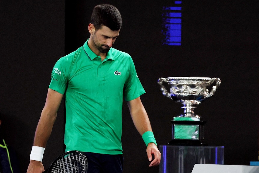 Novak Djokovic walks past the Australian Open title with his head down
