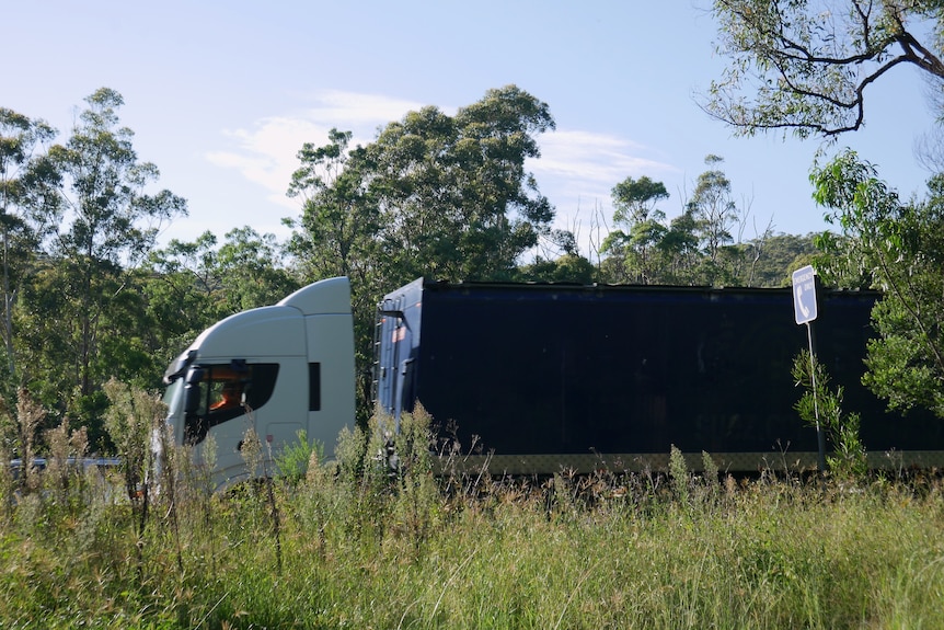 A truck roars past on the M1 Motorway near the Ourimbah Interchange.