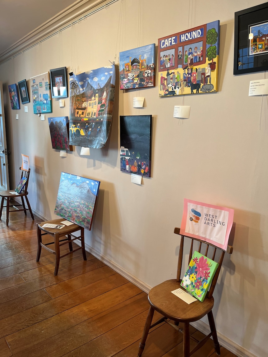 A series of paintings hanging on a wall.