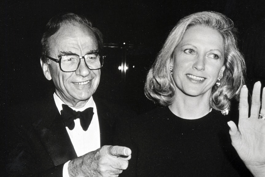 A black and white photo of man with glasses and a women with blonde, short hair