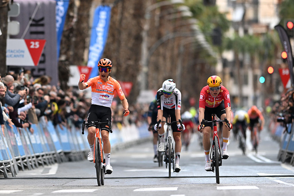 SAN VICENTE DEL RASPEIG, SPAIN - FEBRUARY 06: (L-R) Andrew August of United States and Team INEOS Grenadiers celebrates at finish line as stage winner ahead of Florian Vermeersch of Belgium UAE Team Emirates - XRG and Adne Holter of Norway and Team Uno-X Mobility during the 77th Volta Comunitat Valenciana 2026, Stage 3 a 158km stage from Orihuela to San Vicente del Raspeig 115m on February 06, 2026 in San Vicente del Raspeig, Spain. (Photo by Szymon Gruchalski/Getty Images)