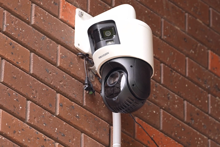 A web camera bolted into a brick wall.