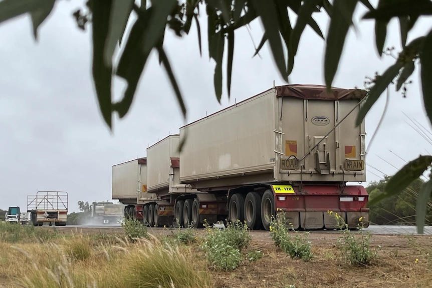 Unhitched trailers for heavy vehicles parked up.
