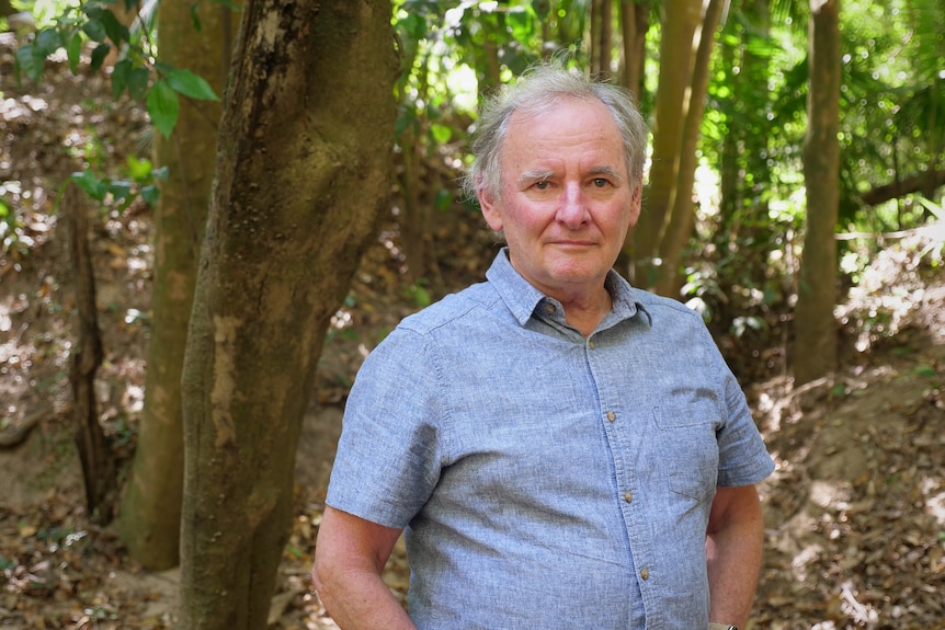 Gary Chestnut stand near a tree in the wetlands.