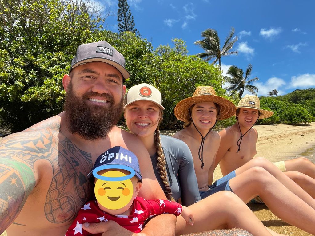 photo of travis browne on the beach with ronda rousey and two sons