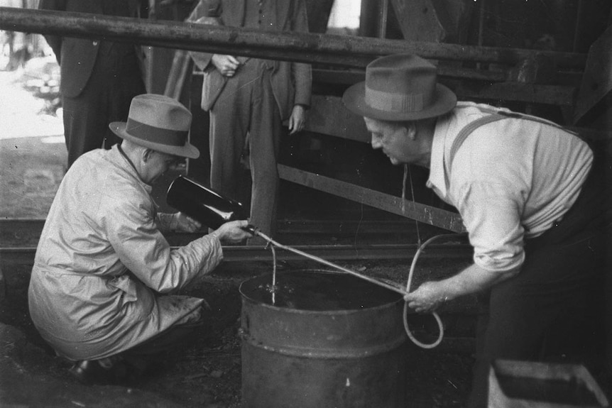 two officials inspecting a coal mine site.