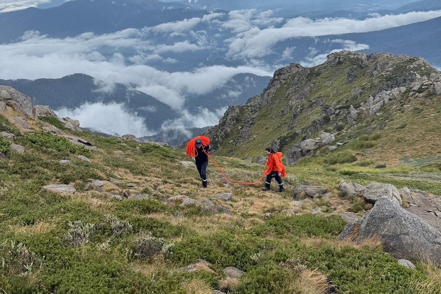 Rescue crews scaling a mountain.