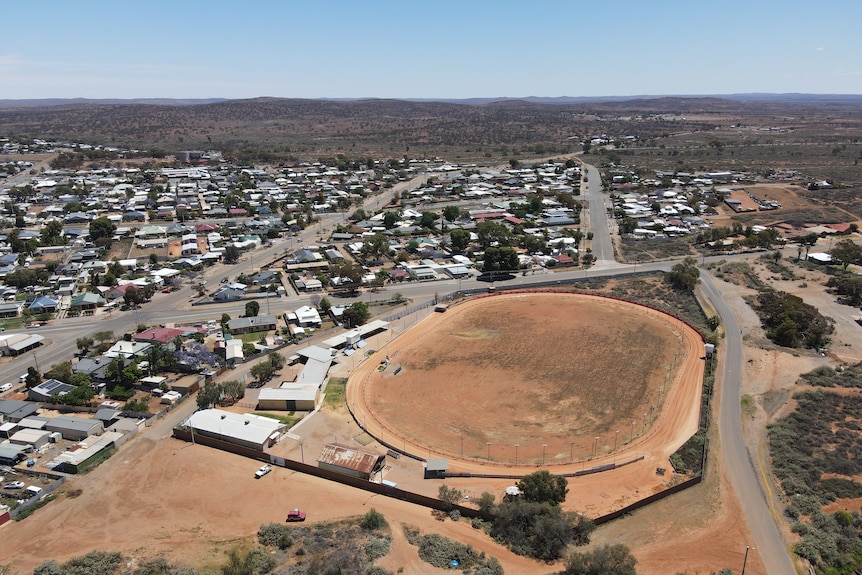 Aerial view of red dirt race track in outback.