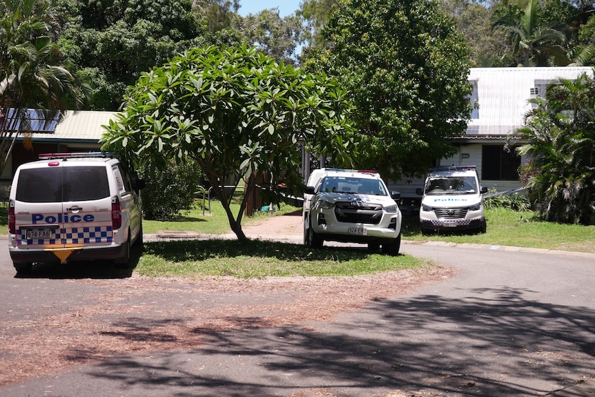 Three police cars and vans in Townsville street