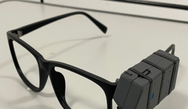 Black framed glasses with a big black box attached to the right hand arm which records and takes photos.