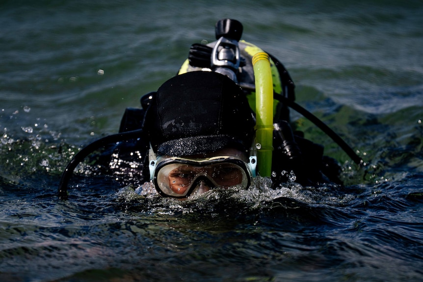 Man with diving gear in the ocean