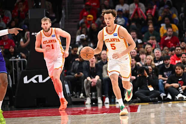 Dyson Daniels dribbles the ball in front of Jock Landale.
