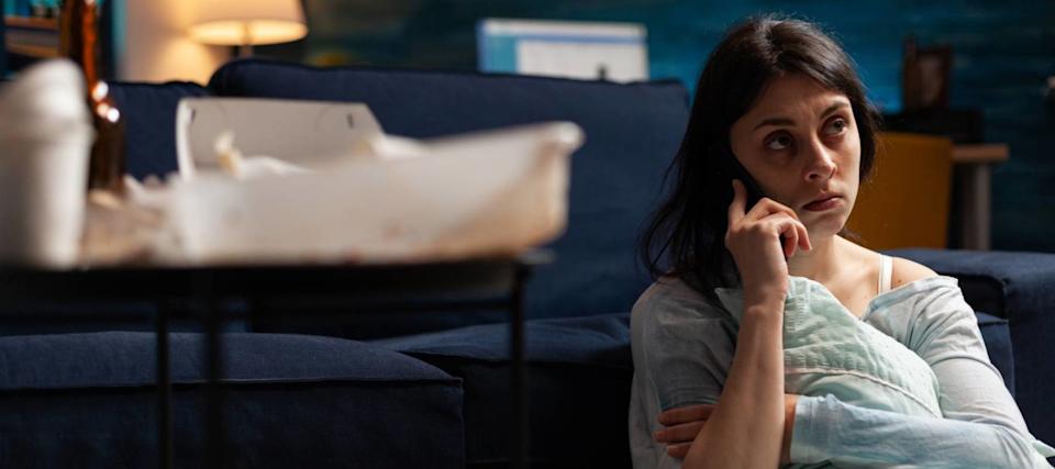 A woman worries about credit-card bills.