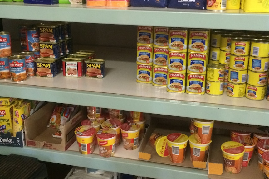 Rows of shelves with dry goods without prices.