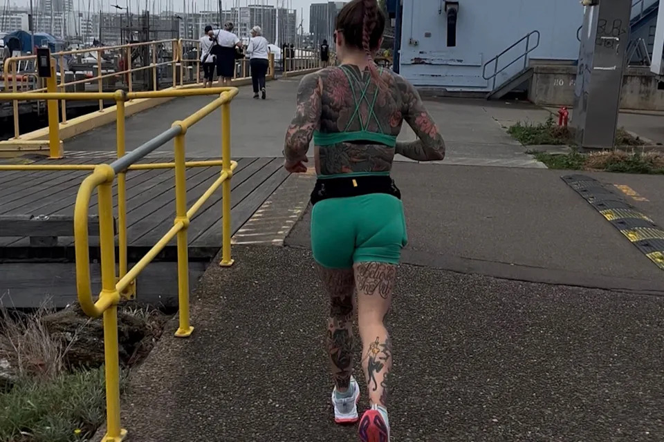 Tattoo artists Maddi Darcey while running. 