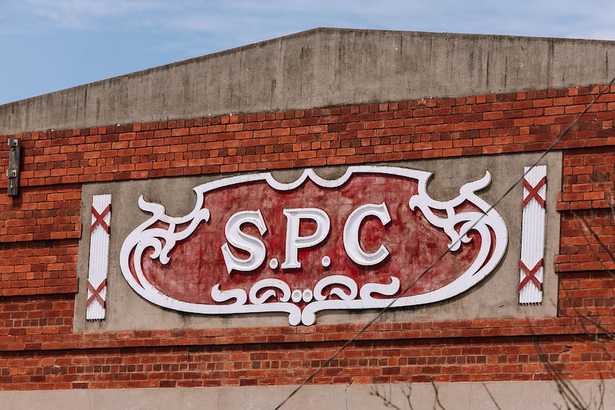 A logo that says "SPC" on a brick building.