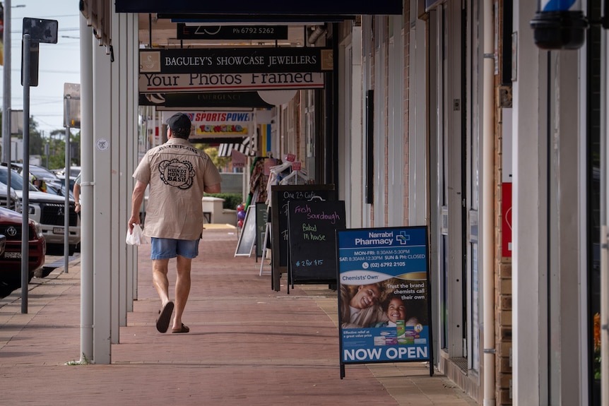 man walks down main street of Narrabri