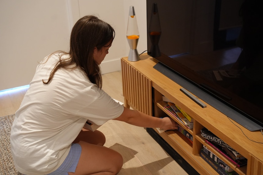 a girl unpacking some books