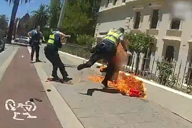 A screenshot of a police video showing officers on fire