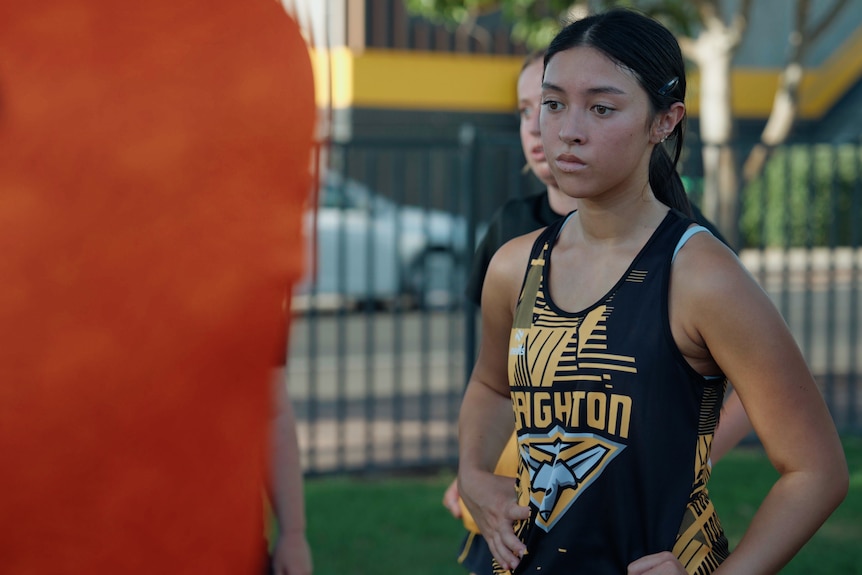 A young woman in football uniform.